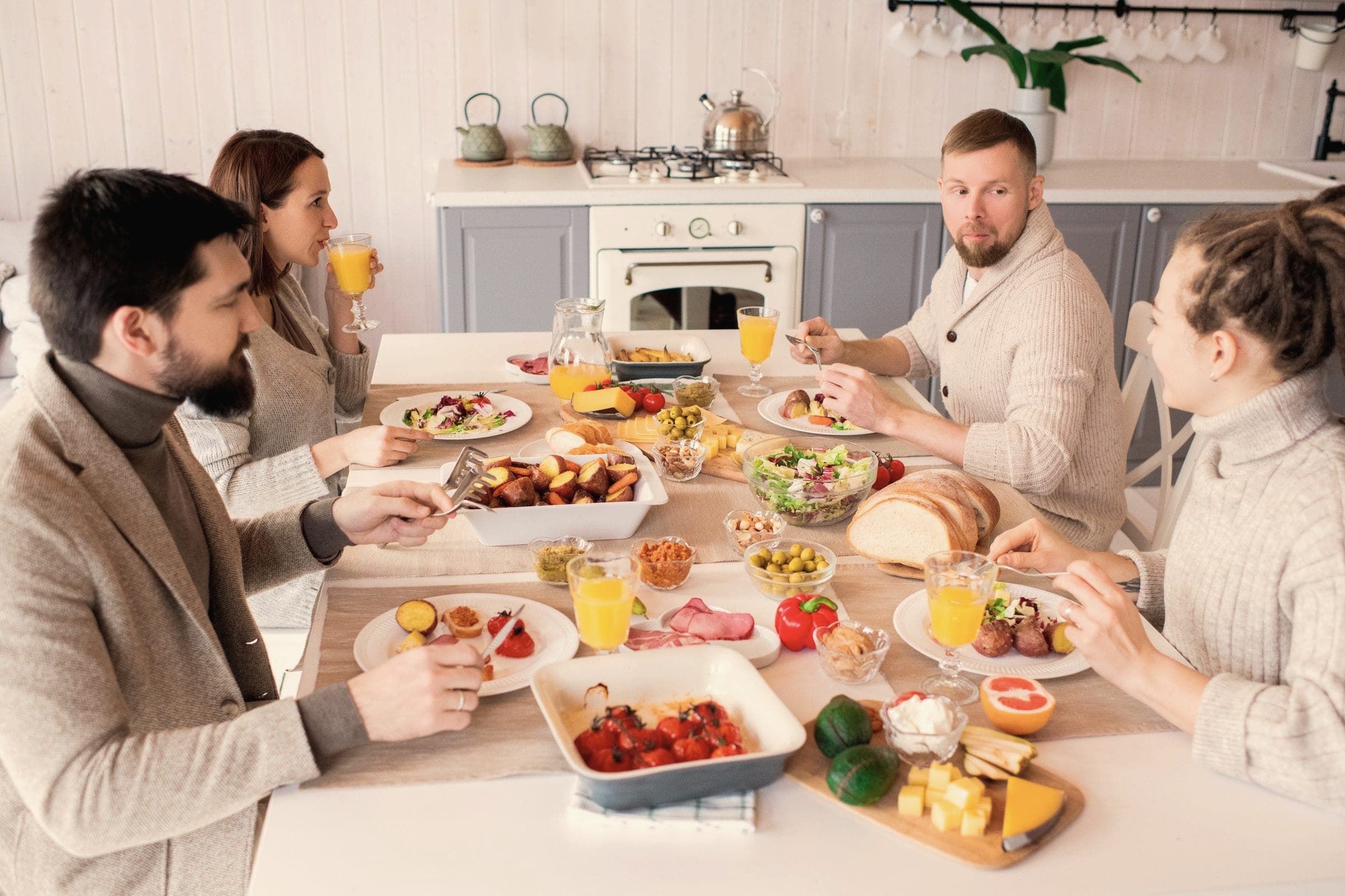 Friends sharing a healthy breakfast around a kitchen table