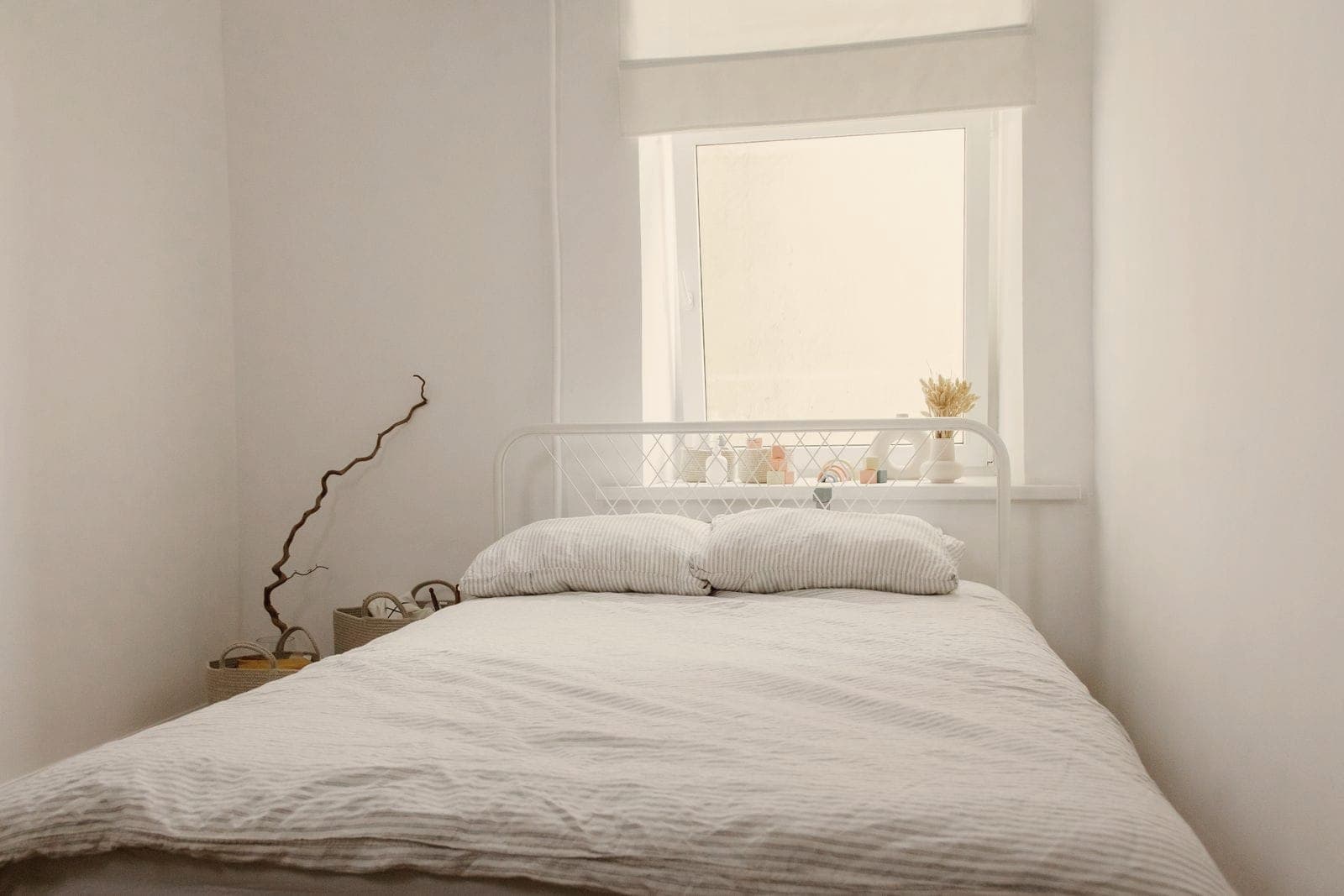 A calm bedroom with a double bed by the window
